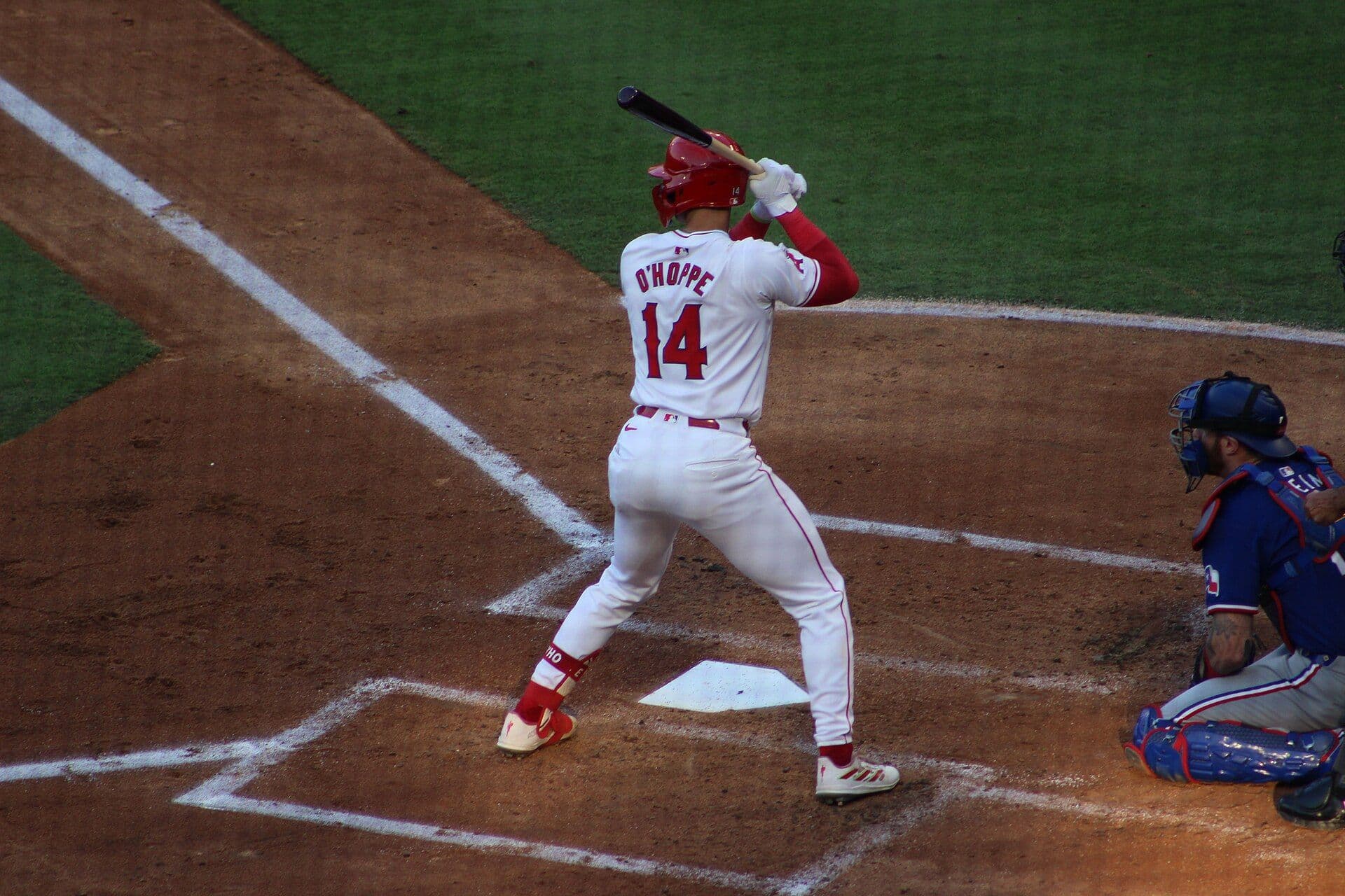 Logan O'Hoppe of the Los Angeles Angels, number 14, standing in the batter's box in a white home uniform