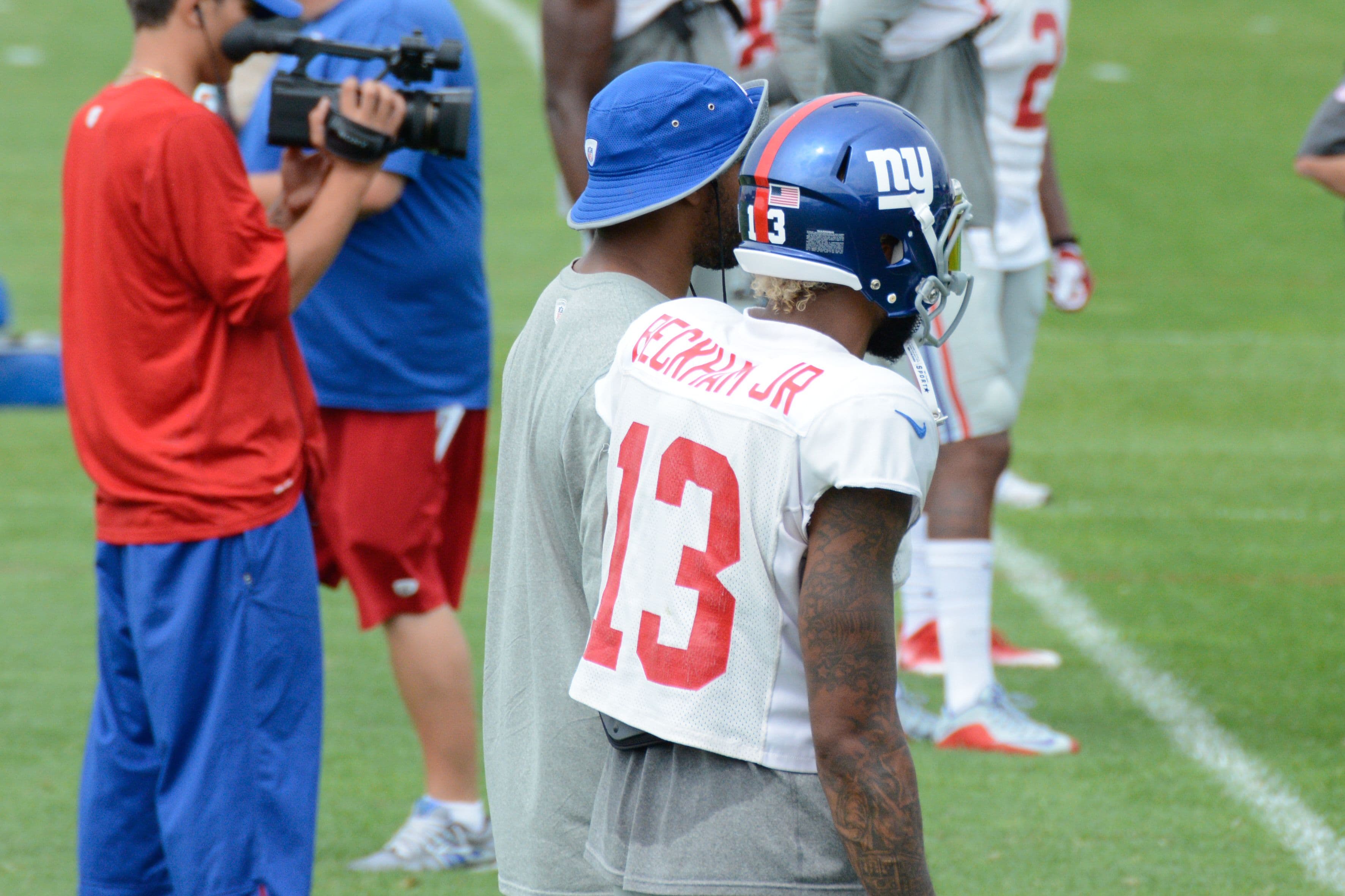 New York Giants players run a drill on an outdoor field during an NFL training camp practice.